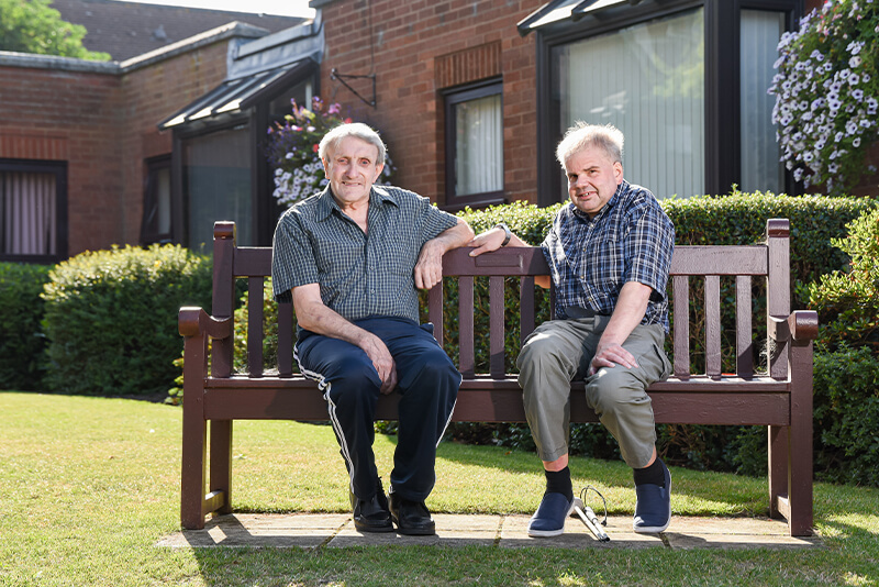 Reg and Stephen sat on a bench