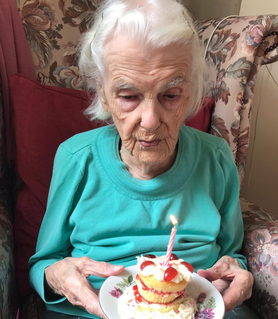 103 Year Old Annie Nicholls Blowing Out A Candle On Her Birthday Cake