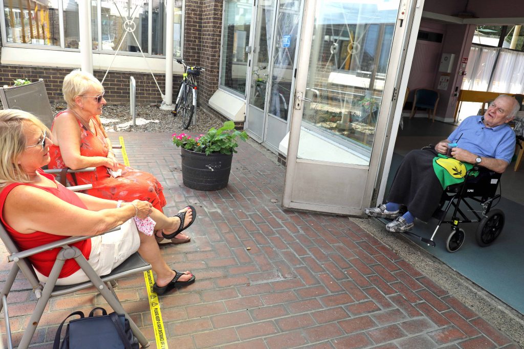 Thomas Tawell House resident Maurice Sadd chats with his sisters