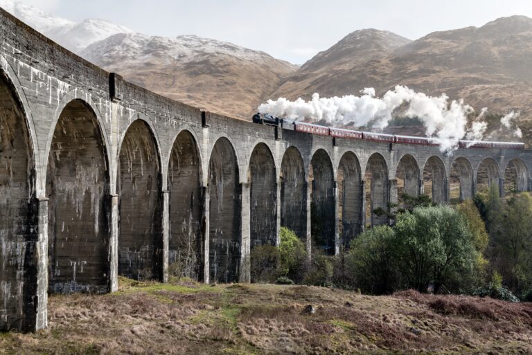Steam train going through the hills from a distance