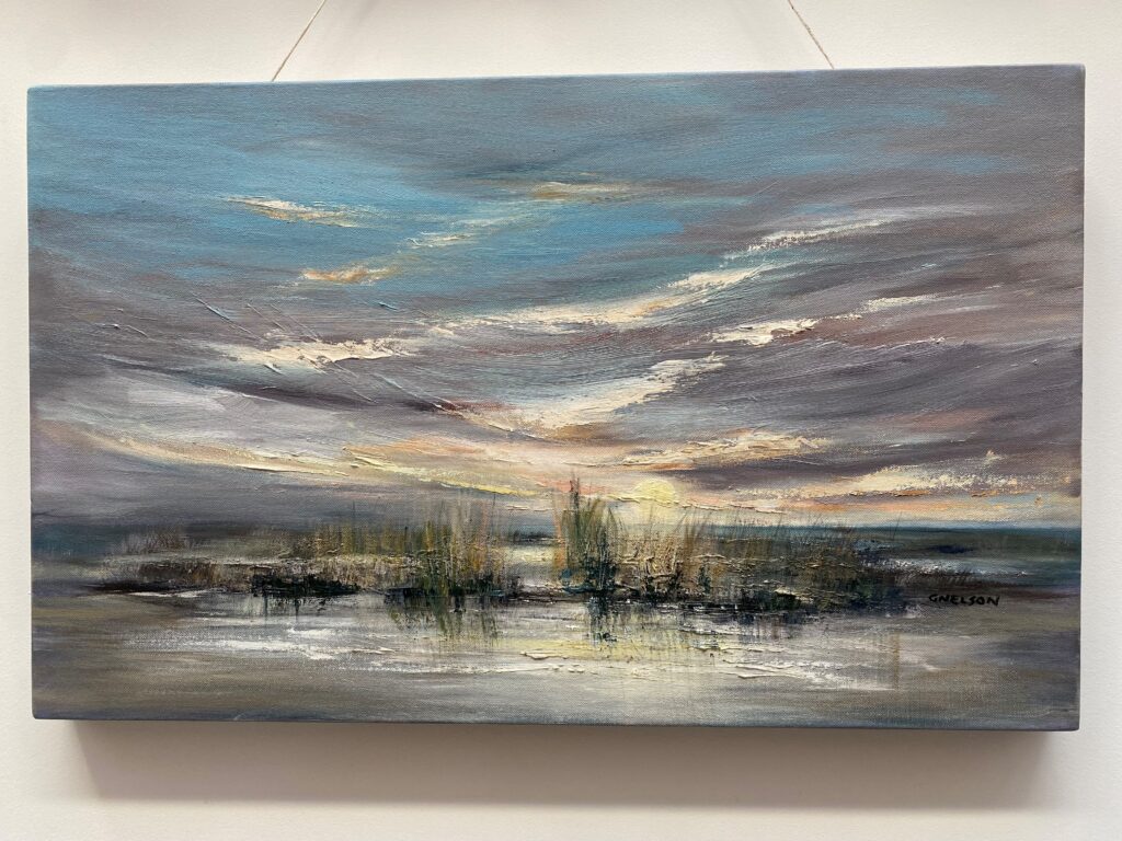 Close up picture of one of the paintings featuring beach grass and a large open sky.