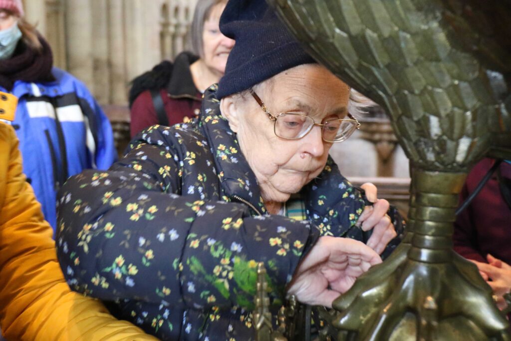 Vision impaired Great Yarmouth woman Brenda Hammond gets hands-on with the lectern at Norwich Cathedral