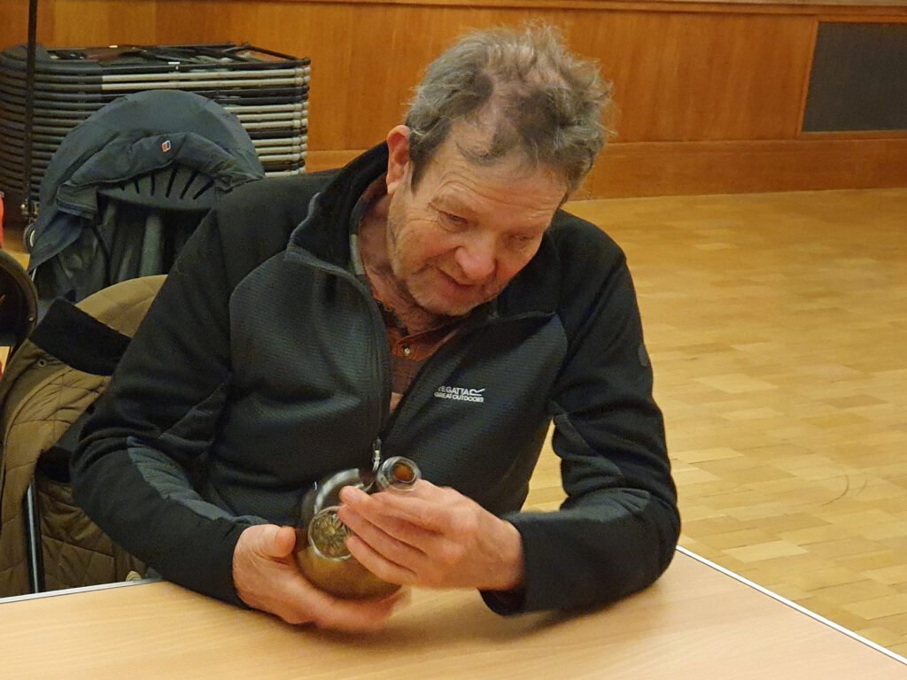 Stephen Seekings handles a replica of a wine bottle from the Gloucester at Norwich Castle Museum
