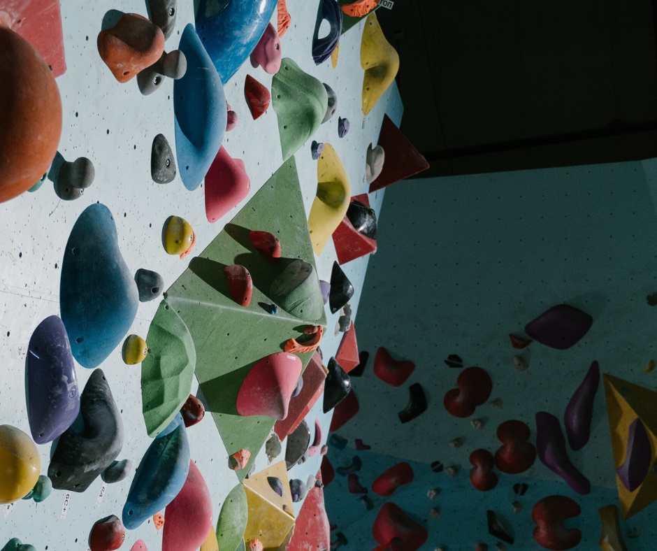 Indoor Climbing wall with hand holds and foot holds of a variety of sizes and colours