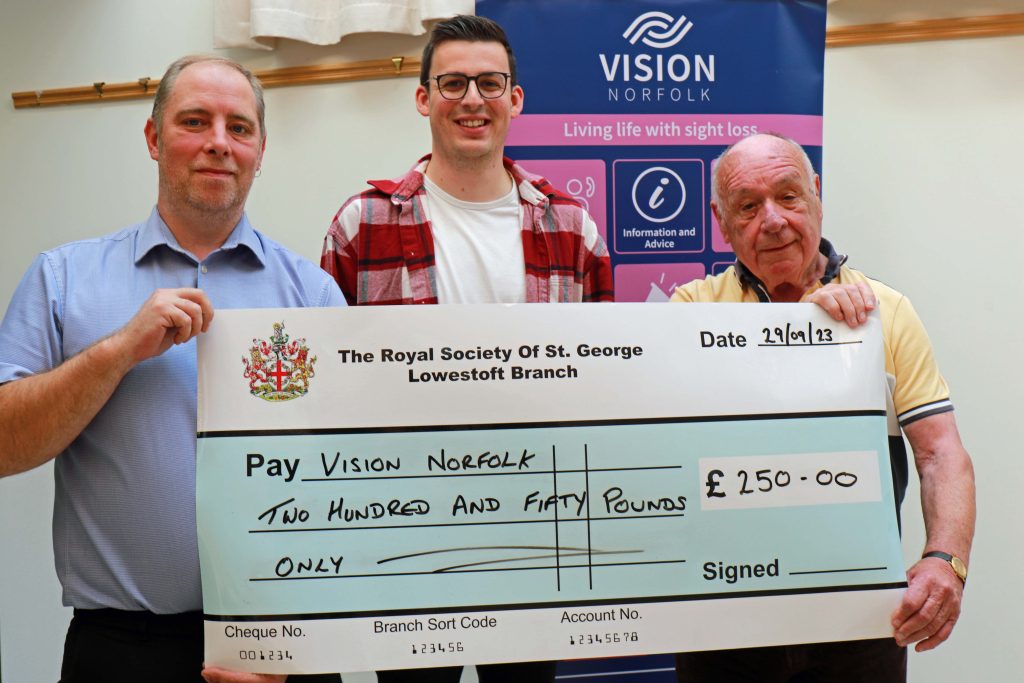 Josh Bartholomew receives the cheque from Paul Debenham and Brian Caton