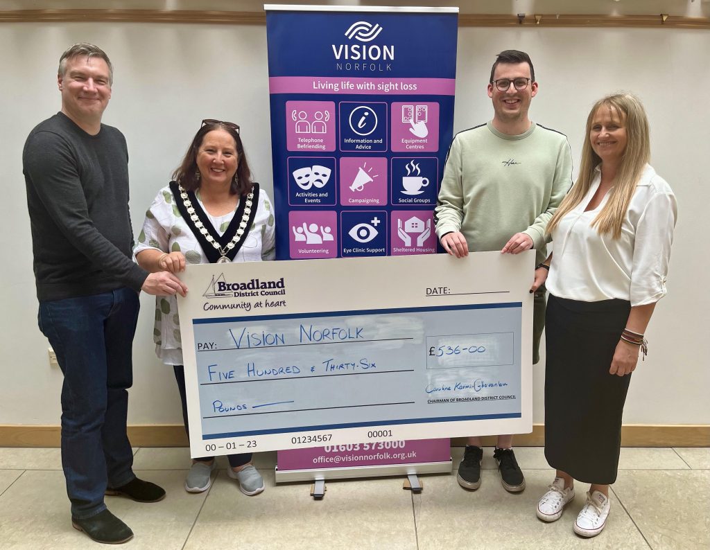 Cllr Caroline Karimi-Ghovanlou hands over the cheque to Vision Norfolk