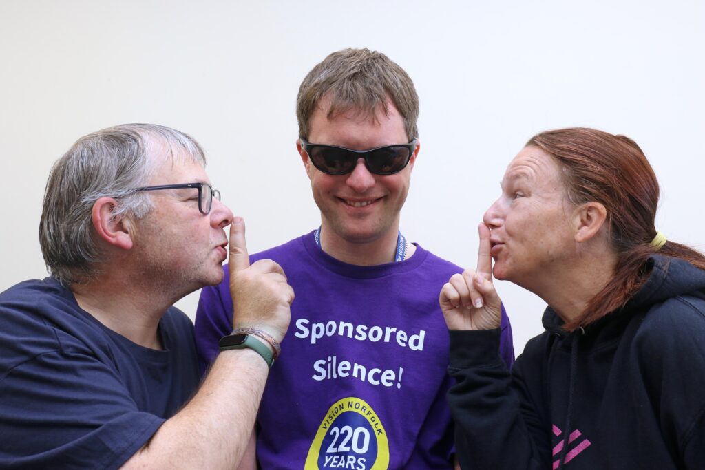 Collegaues Karl Ablitt (left) and Catherine Bond help Ed Bates keep quiet ahead of his sponsored silence