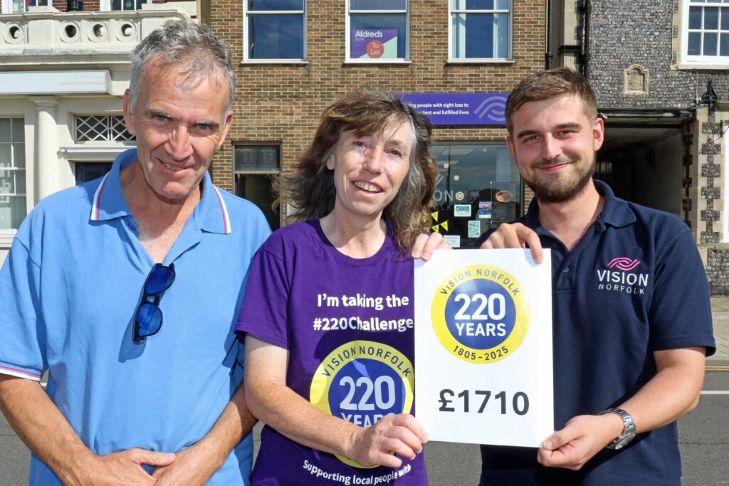 Joe Russell of Vision Norfolk (right) celebrates with vision impaired fundraiser Miranda Reeves and her husband Robert