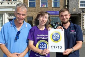 Joe Russell of Vision Norfolk (right) celebrates with vision impaired fundraiser Miranda Reeves and her husband Robert