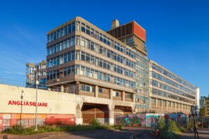 One of the buildings in Anglia Square, Norwich. It is abandoned and there is graffiti on the walls and windows.
