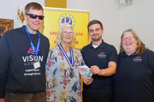Great Yarmouth Probus president Pip Cantwell hands over a donation of £200 to Vision Norfolk fundraising manager Joe Russell