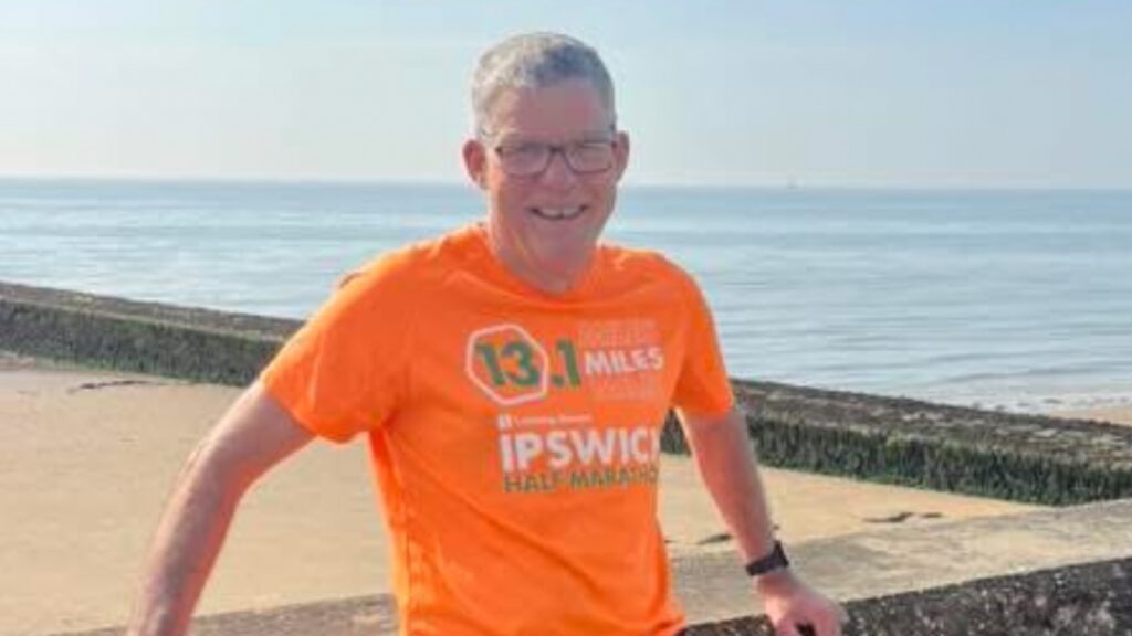 Andrew Menin in an orange Ipswich Half Marathon Shirt.
