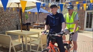 Michael and Robert sitting on a tandem bike.