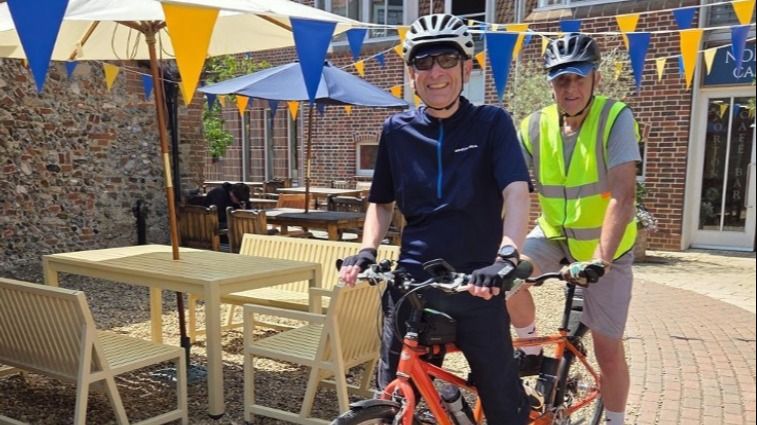 Michael and Robert sitting on a tandem bike.
